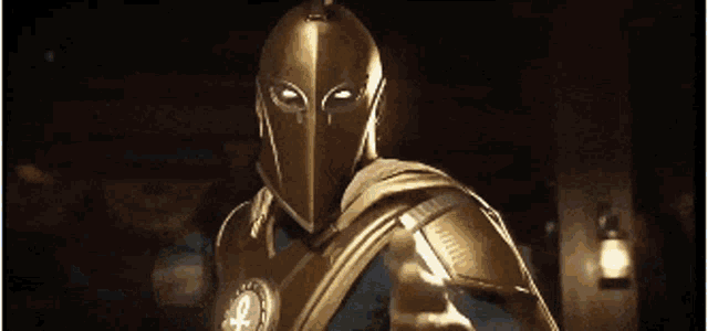 a man wearing a gold helmet and armor is standing in a dark room