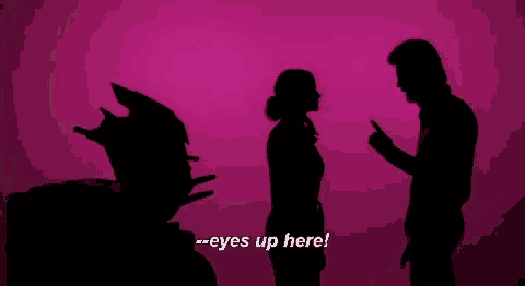 a silhouette of a man and a woman standing next to each other with the words `` eyes up here '' .