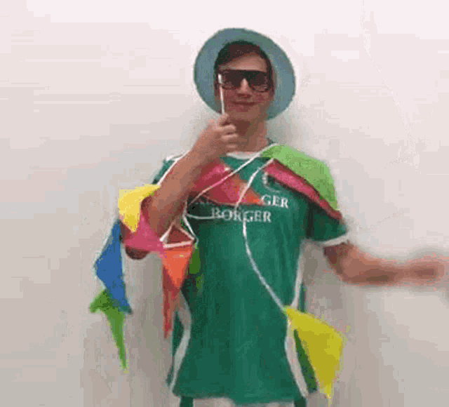 a man wearing a green shirt that says ' berger ' on it