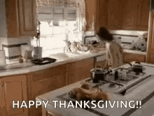 a woman is cooking in a kitchen with the words `` happy thanksgiving '' written on the bottom .