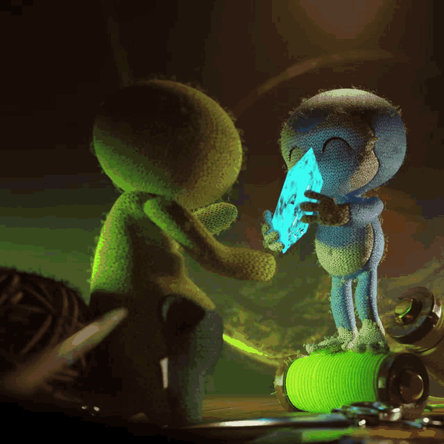 two stuffed animals are standing next to each other one is holding a piece of paper