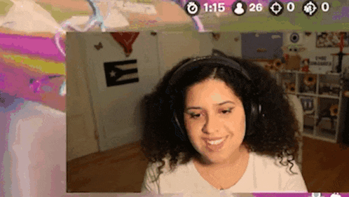 a woman wearing headphones is smiling in front of a wall with a cuban flag