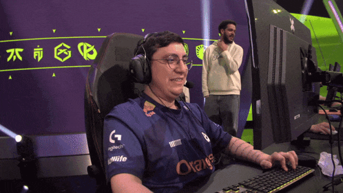 a man wearing headphones and a shirt that says orange