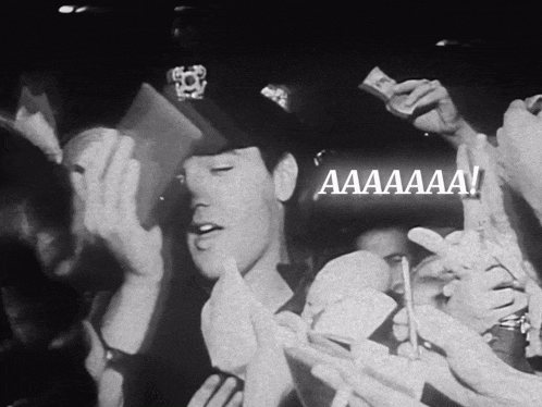 a man in a police hat is surrounded by a crowd and says aaaaa