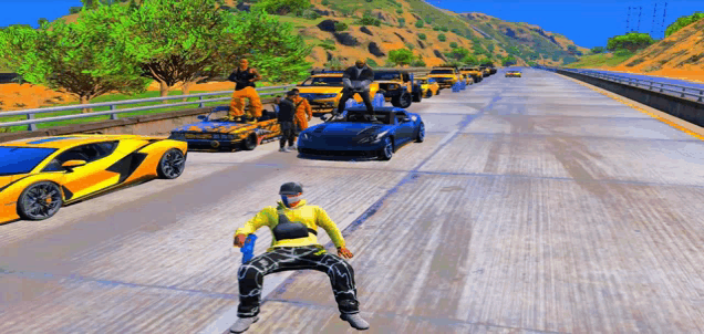 a man in a yellow shirt is standing in the middle of a highway with cars behind him