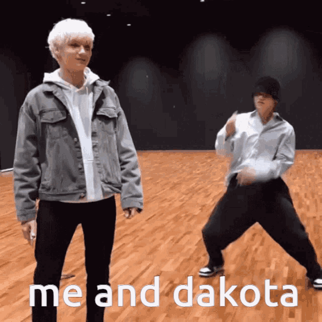 two men are dancing on a wooden floor with the words me and dakota below them