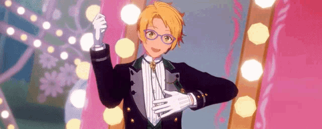 a boy in a tuxedo and gloves is giving a thumbs down sign .