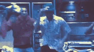 a couple of men are dancing together in a room .