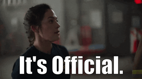 a woman says it 's official in front of a computer