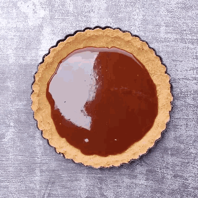 a pie crust is covered in a brown liquid
