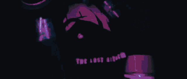 a man is playing drums in a dark room with smoke coming out of it .