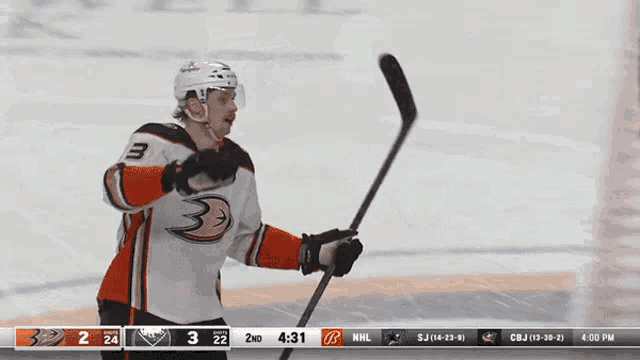 a hockey player with the number 3 on his jersey stands on the ice