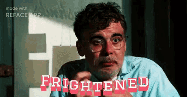 a man with glasses and a mustache is making a funny face and the words frightened are on the screen .