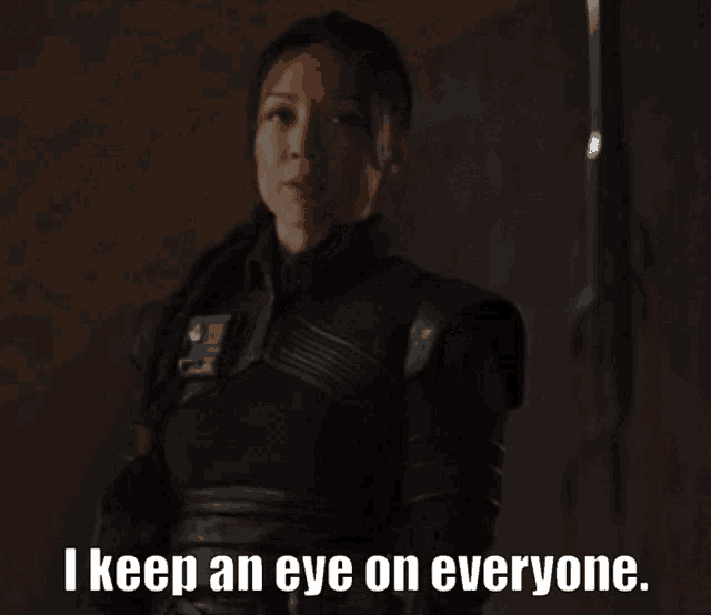 a woman in a black suit says " i keep an eye on everyone "
