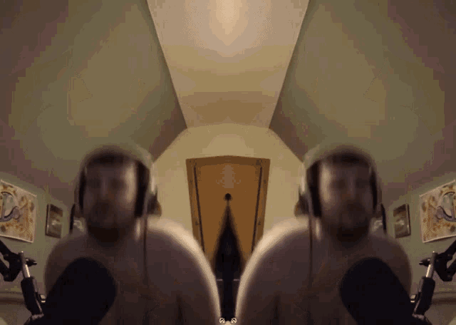 two naked men wearing headphones are sitting in front of microphones in a room