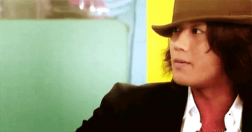 a man wearing a brown hat and a black jacket