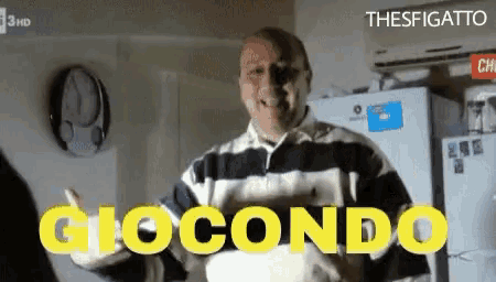 a man in a striped shirt stands in front of a refrigerator and says giocondo