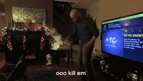 a man is dancing in front of a tv screen that says mc music choice