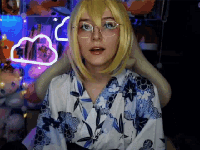 a woman wearing a blue and white kimono and glasses looks surprised