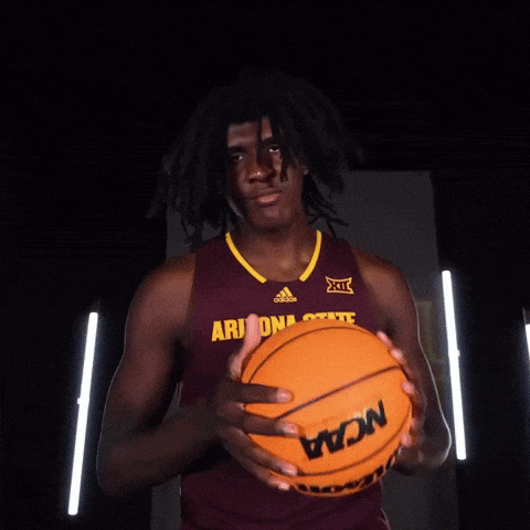 a man in an arizona state jersey holds a basketball in his hands