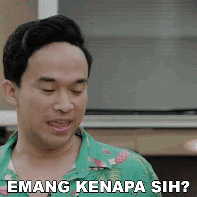 a man in a green shirt is making a funny face and says emang kenapa sih ?