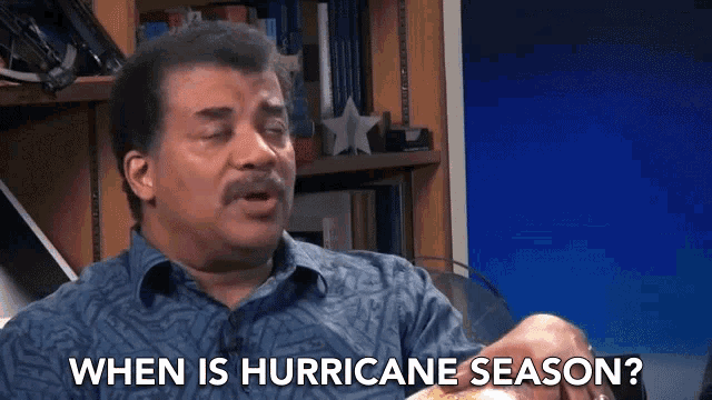 a man says when is hurricane season in front of a bookshelf