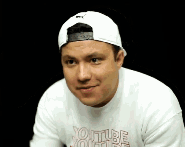 a man wearing a white hat and a white youtube sweatshirt