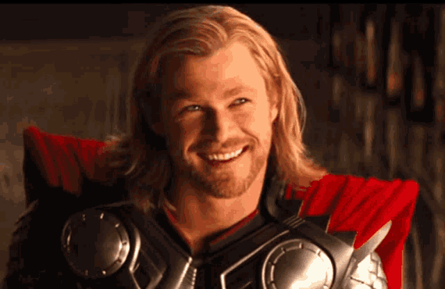 a man with long hair and a beard is smiling