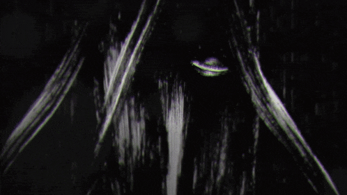 a close up of a person 's face in the dark with a blurred background .