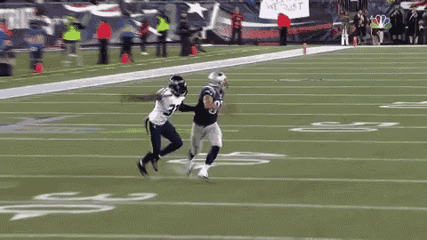 a football player with the number 8 on his jersey is running on a field