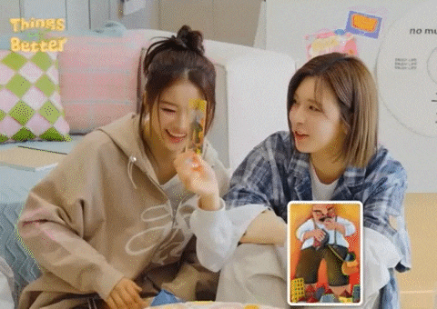 two women are sitting next to each other on a couch .