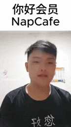 a young man is wearing a black shirt with chinese writing on it .