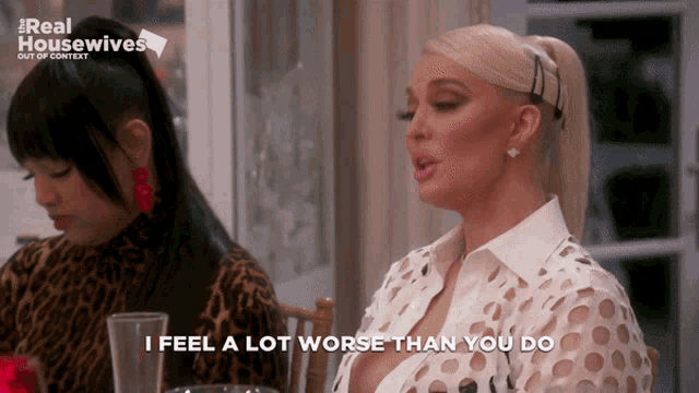 two women sit at a table with the words i feel a lot worse than you do on the bottom