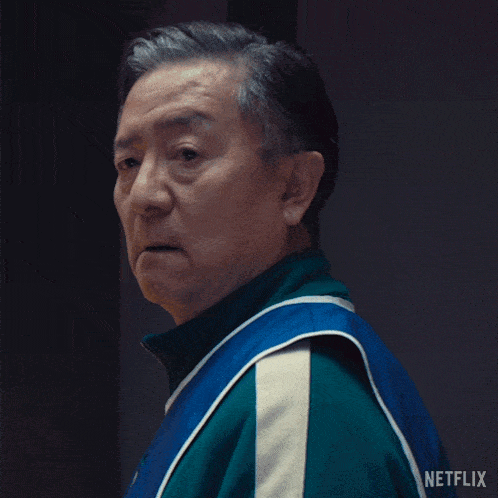 a man wearing a blue and green jacket with netflix written on it