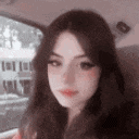a girl is taking a selfie in a car .
