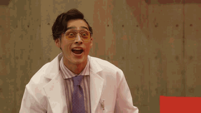 a man wearing a lab coat and sunglasses makes a funny face