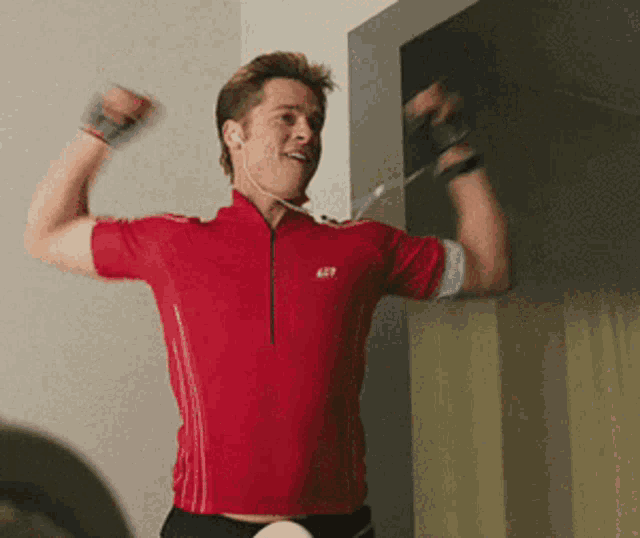 a man wearing a red shirt with the letters ast on it