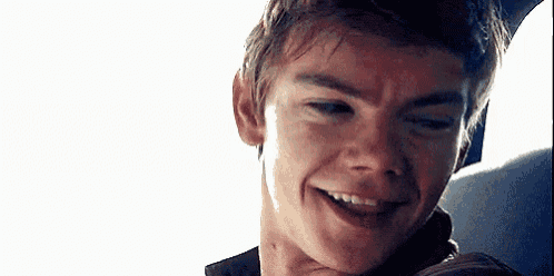 a close up of a young man 's face smiling .