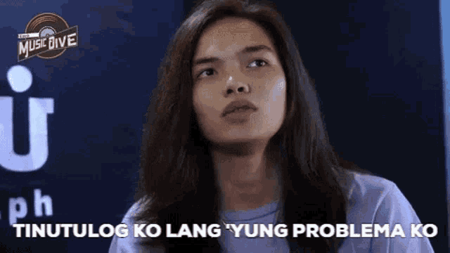 a woman with long hair is making a funny face and saying yung problema ko