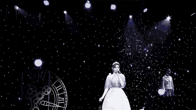 a woman singing into a microphone with a crown on her head