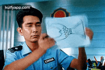a man in a police uniform is holding a piece of paper with a fish on it .