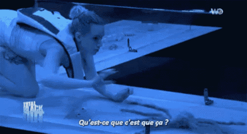 a woman is crawling on a table with the words " qu'est-ce que c'est que ca " on the bottom