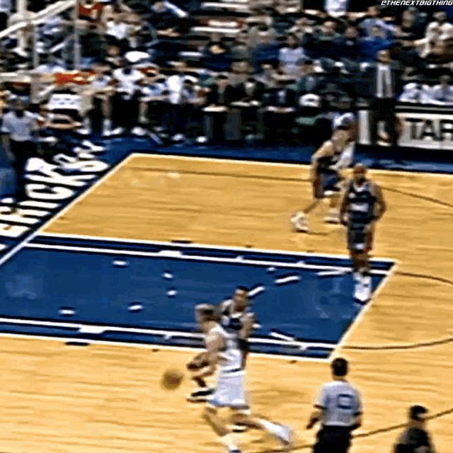 a basketball game is being played on a court with a sign that says bucks on it