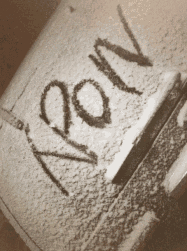 a black and white photo of a snow covered object that says ' aoov ' on it