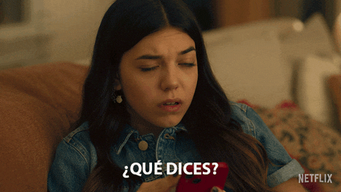 a woman is sitting on a couch with her eyes closed and says " qué dices " in spanish