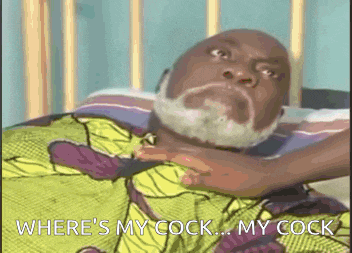 a man with a beard is laying in a bed with the words where 's my cock my cock