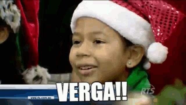 a little girl wearing a santa hat is smiling and says verga