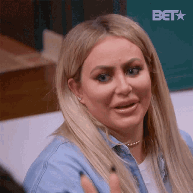 a close up of a woman 's face with a bet logo in the corner .