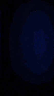 a colorful swirl with a star in the middle on a dark background