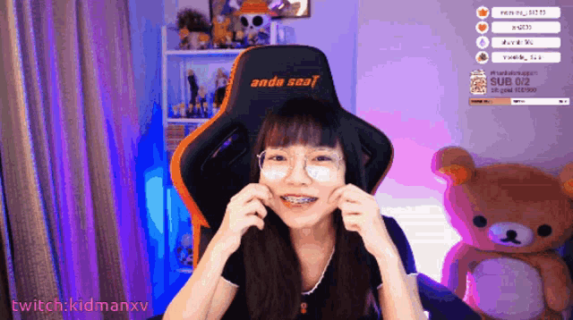 a girl with braces on her teeth is sitting in an orange and black chair